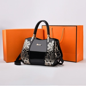 Elegant black patent leather Boston bag with sequin floral embroidery and gold hardware