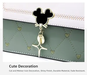 Detail of a chic leather shoulder bag featuring heart quilting and cat-shaped metal clasp