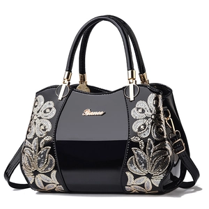 Elegant black patent leather Boston bag with sequin floral embroidery and gold hardware