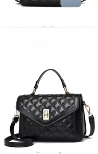 Close-up of black quilted leather handbag featuring a gold-tone rectangular twist lock