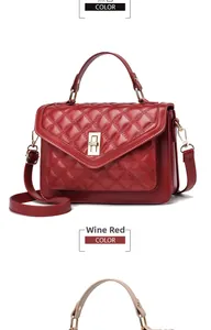 Detail of wine red quilted leather handbag featuring metal twist lock and single handle