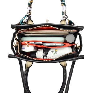 Large PU leather handbag with orange lining showing high capacity for tablets and daily items