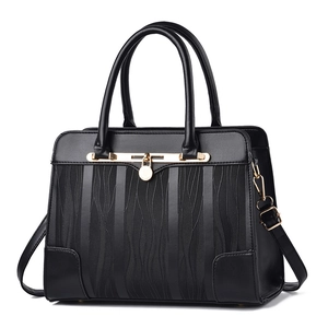 Classic black handbag with wave texture, golden hardware and adjustable shoulder strap