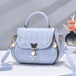 Blue quilted leather crossbody handbag with a Mickey-shaped metal clasp and gold charms