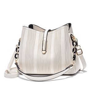 Minimalist cream white bucket bag with wave texture and gold chain strap on white background