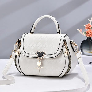 Elegant white quilted shoulder bag with gold hardware and iconic character clasp detail