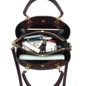 Deep brown multi-compartment handbag with large capacity and golden hardware accents