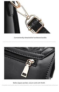 Detail of black leather bag with gold hardware hooks and a secure back zipper pocket