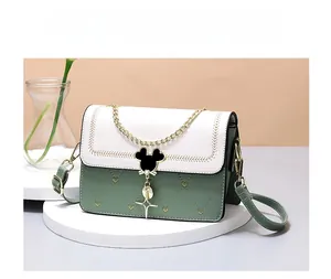 Detail view of contrast leather crossbody bag with Mickey silhouette clasp and star charm
