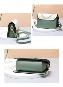 Detail view of the green and white contrast leather crossbody bag with gold hardware