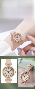 Detail of rose gold watch with Roman numerals dial and pink leather strap with crystals