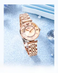 Macro shot of rose gold mesh strap watch with sparkling rhinestone dial and metal marker