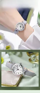 Close-up of Gedi watch with rhinestone X-link detail and gray leather strap