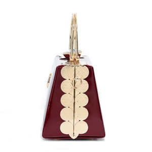 Deep red shiny patent leather mini handbag with gold metal handles and trim accents