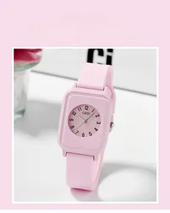 Detail of pink silicone strap and square dial of a stylish waterproof quartz watch