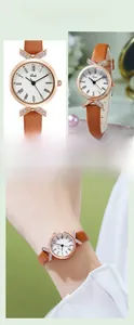Detail of Gedi rose gold watch featuring Roman numerals and X-shaped diamond accents