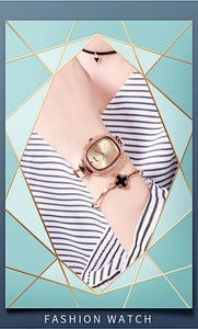 Detailed shot of rose gold fashion watch and black clover bracelet on woman wrist
