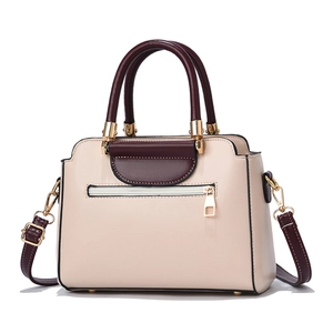 Chic cream tote bag with burgundy straps and gold hardware in a sleek front-facing view