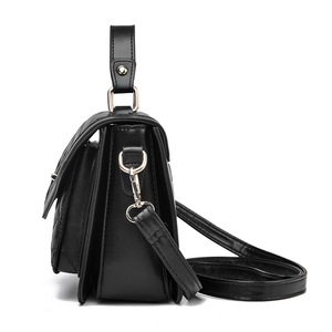 Quilted black leather handbag with gold metal hardware and adjustable shoulder strap