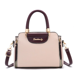 Fashionable beige and burgundy contrast leather handbag with adjustable crossbody strap