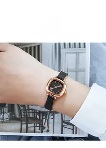 Close-up of GEDI rose gold square watch with black mesh strap worn by a model