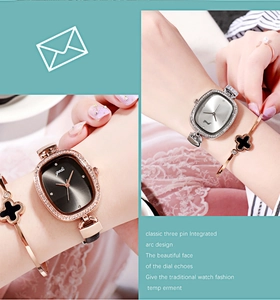Detail of vintage square ladies watch with diamond bezel and leather strap on model wrist