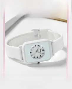 Detail of minimalist white silicone square watch with clear black Arabic numerals dial