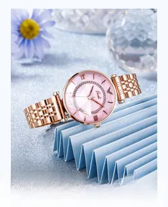Macro detail of luxury rose gold steel watch with rhinestone bezel and pink dial
