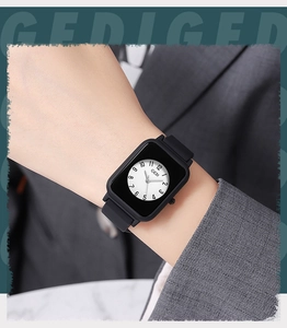 Close-up of GEDI rectangular watch with round dial on wrist with grey suit