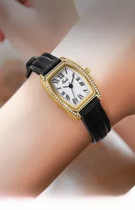 Close-up of Gedi tonneau watch with crystal bezel and black leather strap on wrist