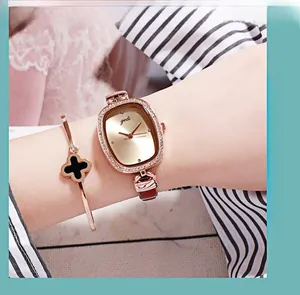 Elegant rose gold tonneau watch with red leather strap and clover charm bracelet