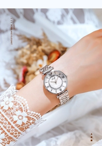 Close-up of elegant silver stainless steel watch with Roman numerals and rhinestone bezel