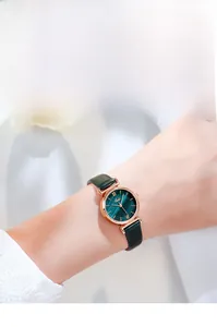 Close-up of Gedi quartz watch with dark green dial and rose gold case on wrist