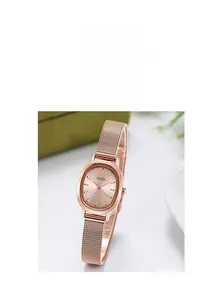 Detail view of oval rose gold watch dial with elegant mesh metal strap for women