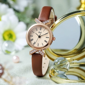 Fashionable women's rose gold watch with brown leather strap and roman numeral dial