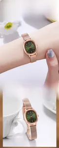 Elegant oval women's watch with rose gold mesh strap and green dial in casual lifestyle scene