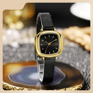 GEDI luxury women quartz watch with square gold case and black mesh strap on soft background