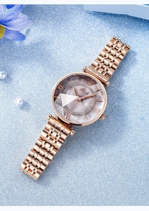 Detail of rose gold steel watch with rhinestone bezel and mother of pearl dial
