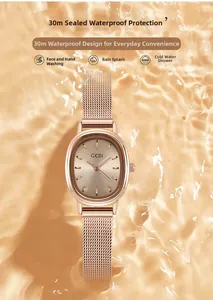 Detail of rose gold oval watch submerged in rippling water showing 30M water resistance