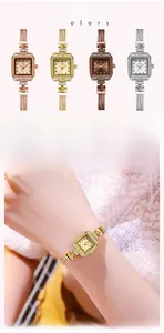 Detail of luxury square dial watches with rhinestone accents and vintage metal mesh bands