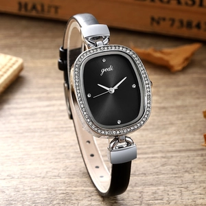 Retro oval ladies watch with black leather strap and sparkling rhinestone bezel