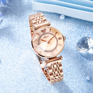 Elegant rose gold steel watch with mother of pearl dial and crystal bezel on blue background