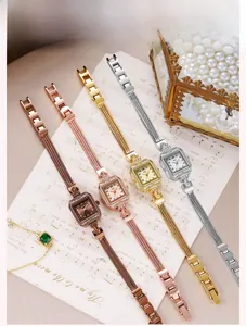 Detail of four luxury square dial watches with crystal bezels and snake chain metal bands