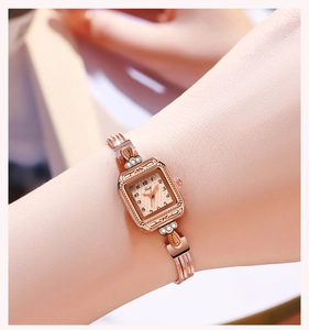 Close-up of a ladies' rose gold square watch featuring a diamond-pattern dial and mesh band