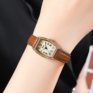 Vintage tonneau quartz watch with Roman numerals and diamond-set gold case on leather strap