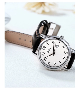 Close-up of GEDI vintage quartz watch featuring a white dial and black leather strap
