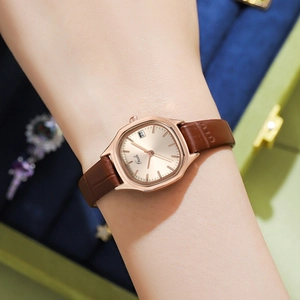 Gedi women's tonneau rose gold watch with brown leather strap and date display on wrist
