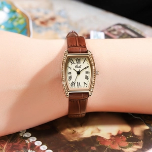Gedi vintage tonneau quartz watch with roman numerals and brown leather strap on wrist