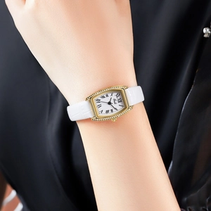 Detail of luxury tonneau quartz watch with crystal bezel and white croc-embossed leather strap