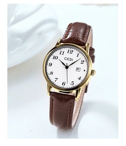 Detail of GEDI vintage watch with gold case, white dial, and brown leather strap